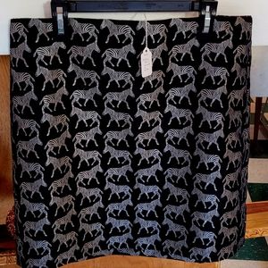 Skirt, black with silver zebras. Above the knee length. Size 6.